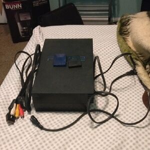 Black Video Game Console with Cables